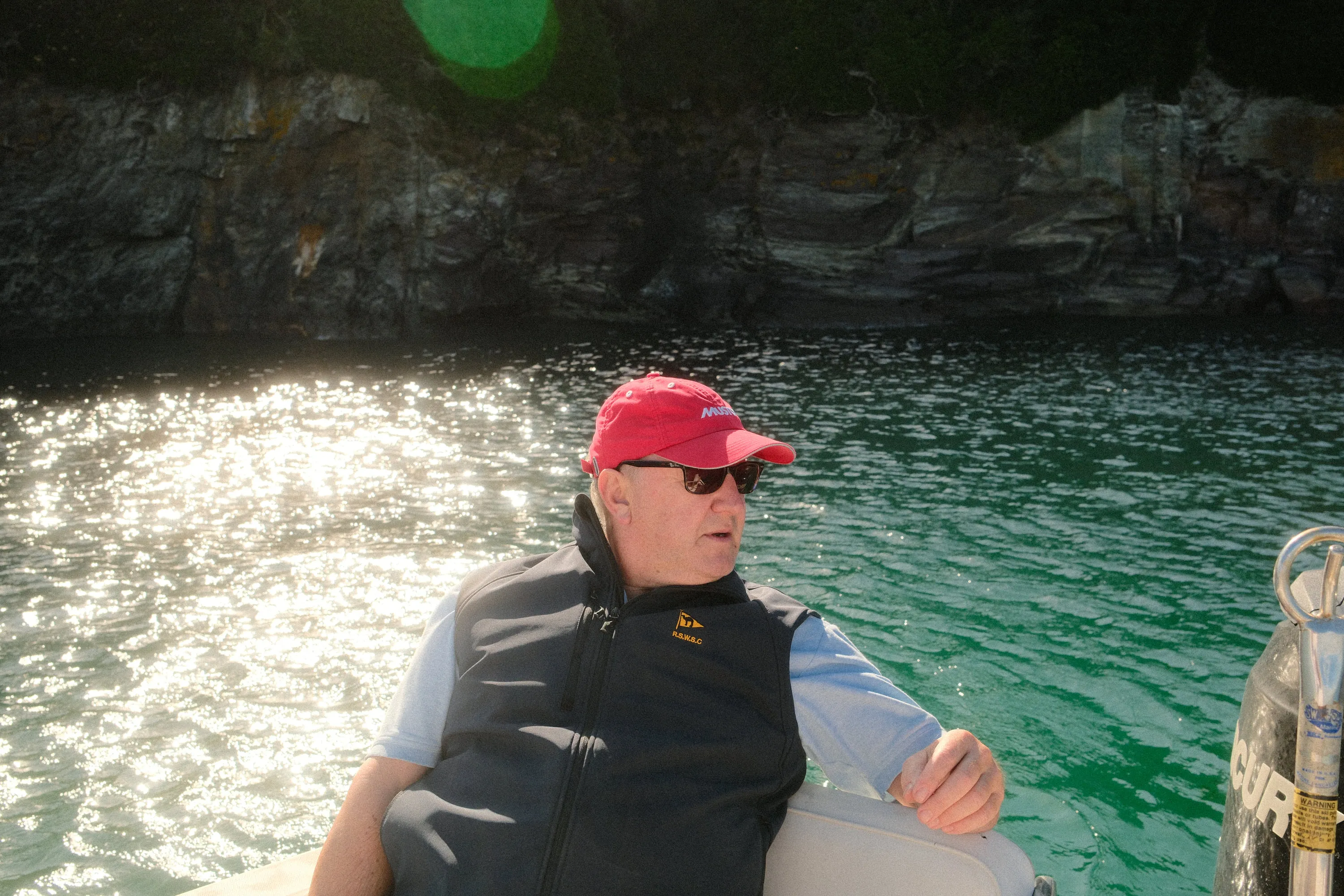 In under the cliffs with the light off the water.